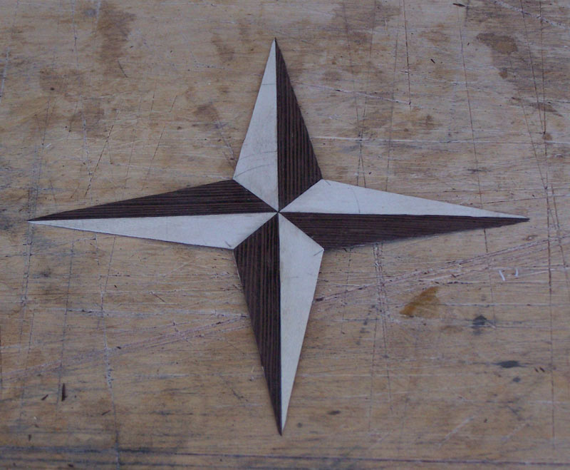 The base of the compass rose cut out